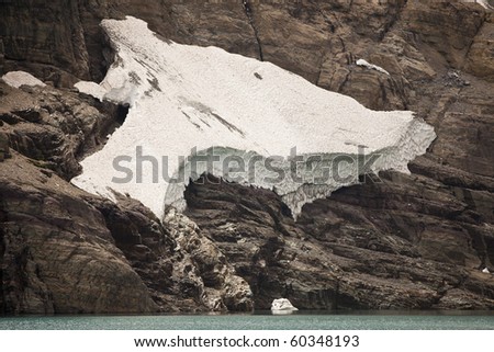 A hanging glacier, or an ice field, that is located on the cliff walls over Iceberg Lake in Glacier National Park. Due to global warming, these glaciers are rapidly disappearing.