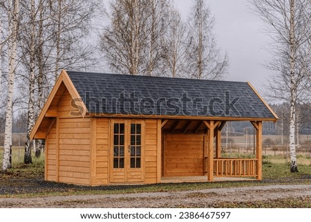 Similar – Foto Bild Holzhaus mit einem zweistufigen Pultdach vor blauem Hintergrund und viel Textfreiraum