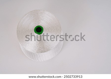 Similar – Image, Stock Photo Spooling up of yarn for knotting on a loom.