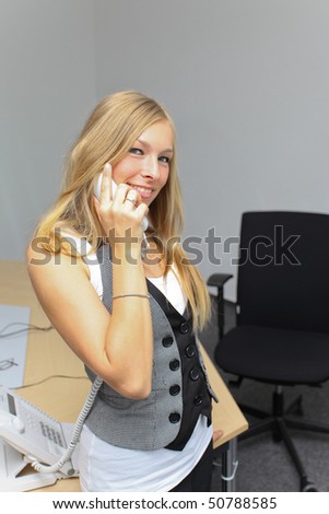 Young blond secretary at the phone