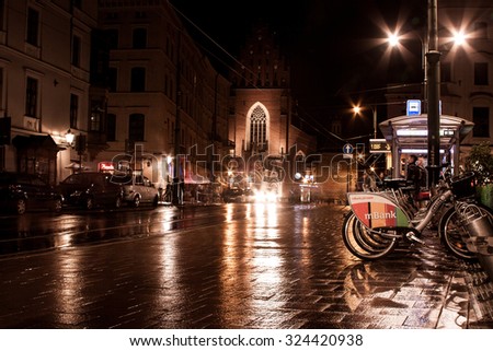 KRAKOW, POLAND - SEPTEMBER 18, 2015: Rent a bike in Krakow. Walking tourists in the old town.