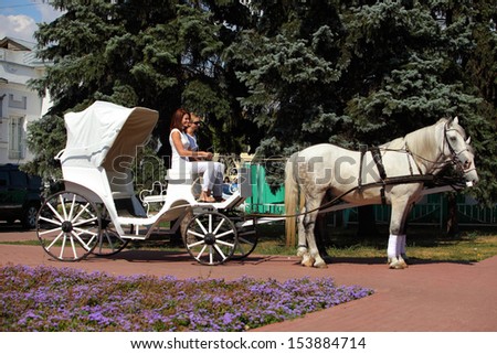 Horse wedding carriage and two  girl-driver