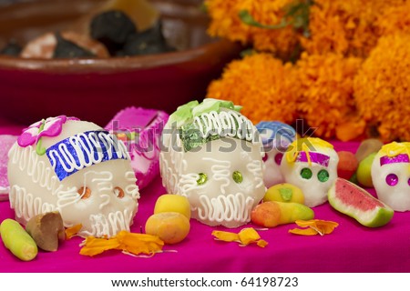 Mexican offering for the dead showing sugar skulls and assorted traditional candy. Holiday Dia de los Muertos.