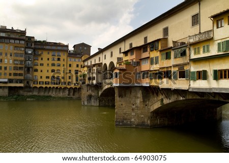 Arno river in Florence Italy with houses Ponte Veccio seen from the side. All signs and IDs cloned out.