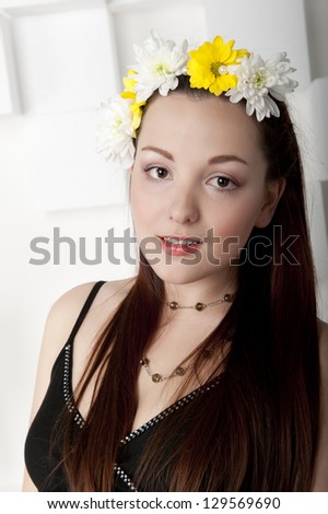 Portrait of a young beautiful woman with flowers