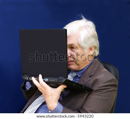 Senior executive  looking closely at his laptop