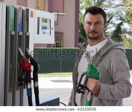 Customer Refilling Car at Gas Station