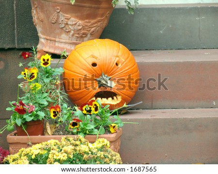 A jack-o-lantern sitting on the front steps, welcoming visitors.