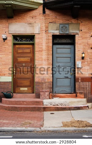 Near symmetry between two front doors, side by side.  Philadelphia, PA.
