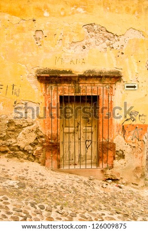 Rustic colonial building on a hillside street in old Mexico
