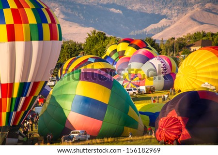 RENO - SEPTEMBER 7: Hot air balloon teams rush to inflate their balloons to start the 38th annual Great Reno Balloon Race in Reno, Nevada on Sept. 7, 2013