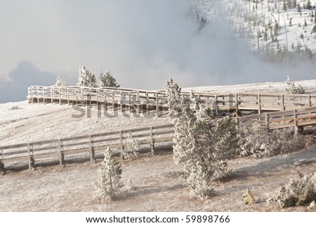 Snow and ice coat boardwalks at Yellowstone Park\'s Midway Geyser Basin