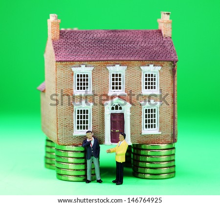 A real estate agent and a prospective buyer in front of a house on gold coin stilts, with the prospective buyer baulking with a real thinkers pose, suggesting you have to find the buyers green button!