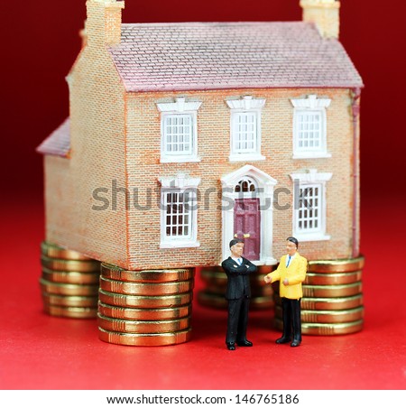 A real estate agent and a prospective buyer in front of a house on gold coin stilts, with the prospective buyer baulking with a real thinkers pose, suggesting you have to find the buyers green button!