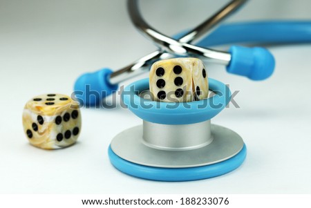 A Doctors light blue stethoscope with two ivory dice with black spots dice placed next to it, asking the question, do you gamble with your health.