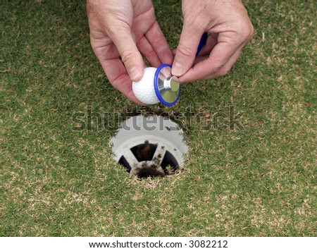 Medical doctor on the golf course checking a gold ball with his stethoscope