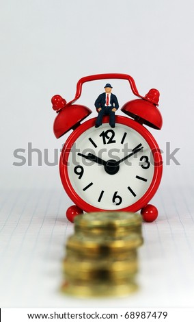 A red alarm clock with the bank manager sat on it with a stairway of gold coins in front it, signifying the longevity of the loan.