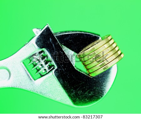 stack of Gold Dollar Coins being squeezed in a silver adjustable spanner, against a light pastel green background and asking the questions how tight  is you household budget?