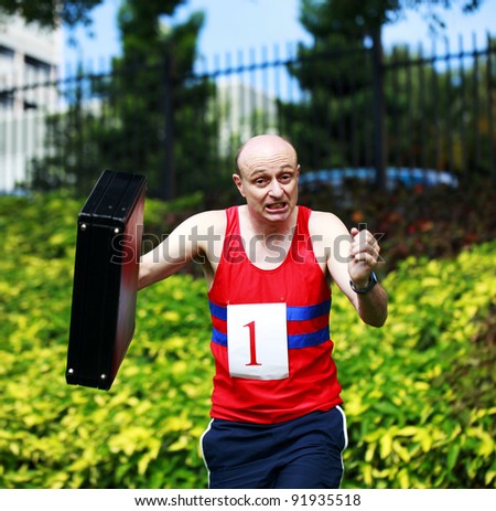A businessman dressed in running attire with the number one on his chest, carrying a briefcase in a beautiful park and obviously running late.