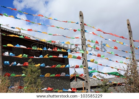 Colorful Tibetan prayer flags fluttering in the wind at the Naxi tribal village at Dongba Valley in Lijiang, Yunnan Province of China.