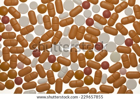 Colorful pills spilled on a white background- Photo taken 10. November 2014