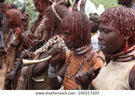 Woman blaring trumpet during bulljumping Rital of Hamar tribe. Africa, south Ethiopia. Photo taken 23.12. 2009