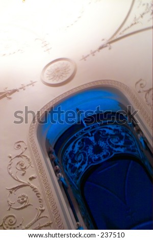 Unusual angle of a balcony, ceiling and decoration - with moody lighting