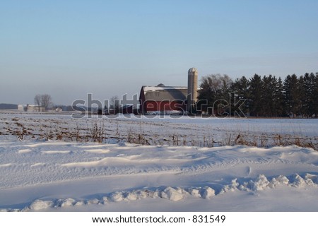 A red barn with silo on the first day of winter in Wisconsin