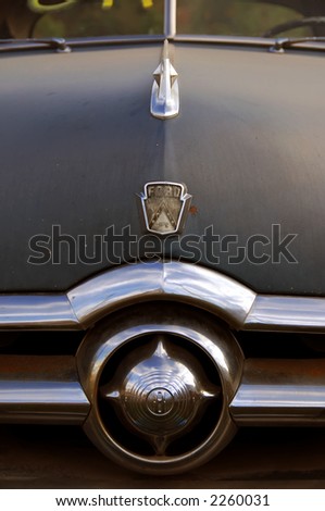 Close-up of vintage automobile hood ornament an grill