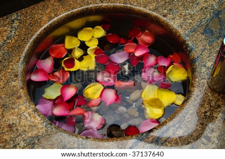 Aroma therapy basin with scented water and floating flower petals