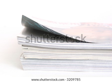 a stack of books  and the first page is opened