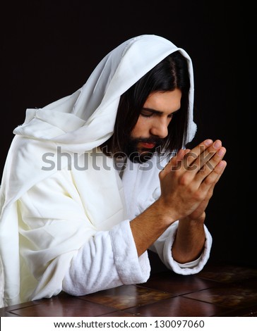Praying Jesus Christ of Nazareth kneeling hands together