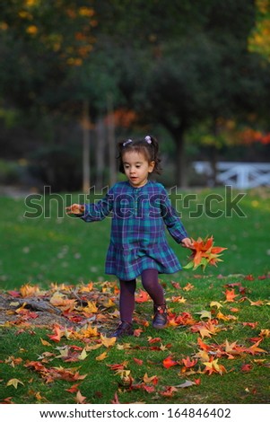 Baby collecting Autumn leaves plaid shirt evening