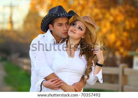 Cowboy and his cowgirl romantically kissing,