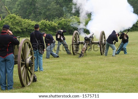 cannon being fired by yankee soldiers in a civil war re-enactment