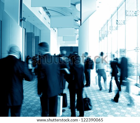 business people rushing in the lobby. motion blur