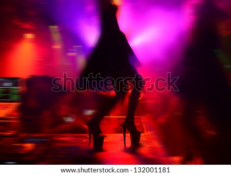 Woman dancing in the nightclub.