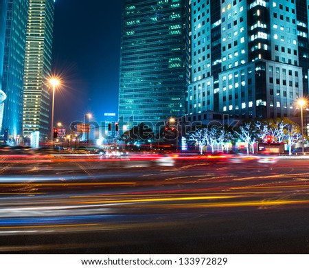 moving car with blur light through modern city at night.