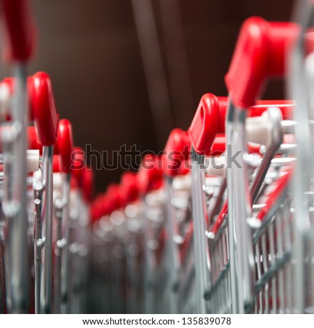 Similar – Image, Stock Photo Lined up shopping trolleys made of shiny wire with red plastic in front of a new supermarket in Bielefeld in the Teutoburg Forest in East Westphalia-Lippe