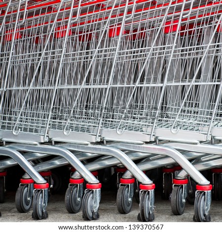 Similar – Image, Stock Photo Lined up shopping trolleys made of shiny wire with red plastic in front of a new supermarket in Bielefeld in the Teutoburg Forest in East Westphalia-Lippe