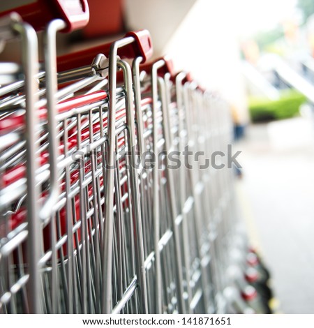 Similar – Image, Stock Photo Lined up shopping trolleys made of shiny wire with red plastic in front of a new supermarket in Bielefeld in the Teutoburg Forest in East Westphalia-Lippe