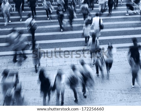 Busy city people on zebra crossing street in Hong Kong, China.