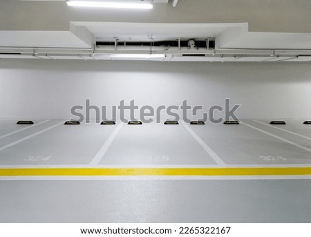 Similar – Image, Stock Photo Empty parking space in the backyard of a commercial / residential area