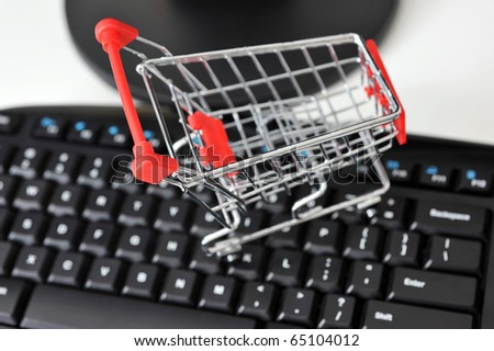 empty shopping cart on the keyboard of computer, on-line shopping concept.
