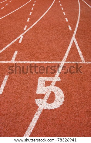 Number five on the start of a running track