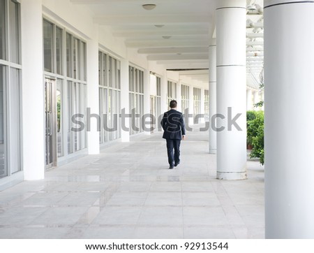 business people walk on the corridor of modern building. rear view