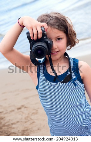 Young Girls taking a photograph with a digital SLR camera