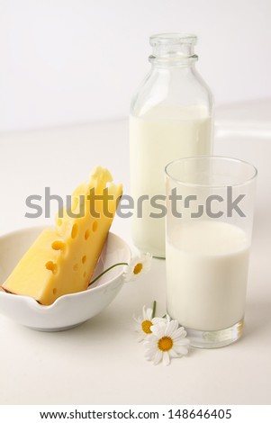 Still life of glass of milk and cheese
