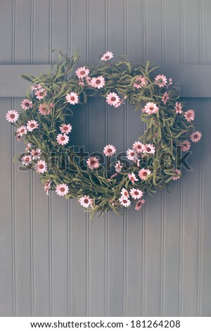 Spring wreath with flowers hanging on hook