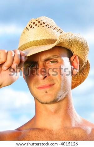 Young man tipping his hat to say hello
